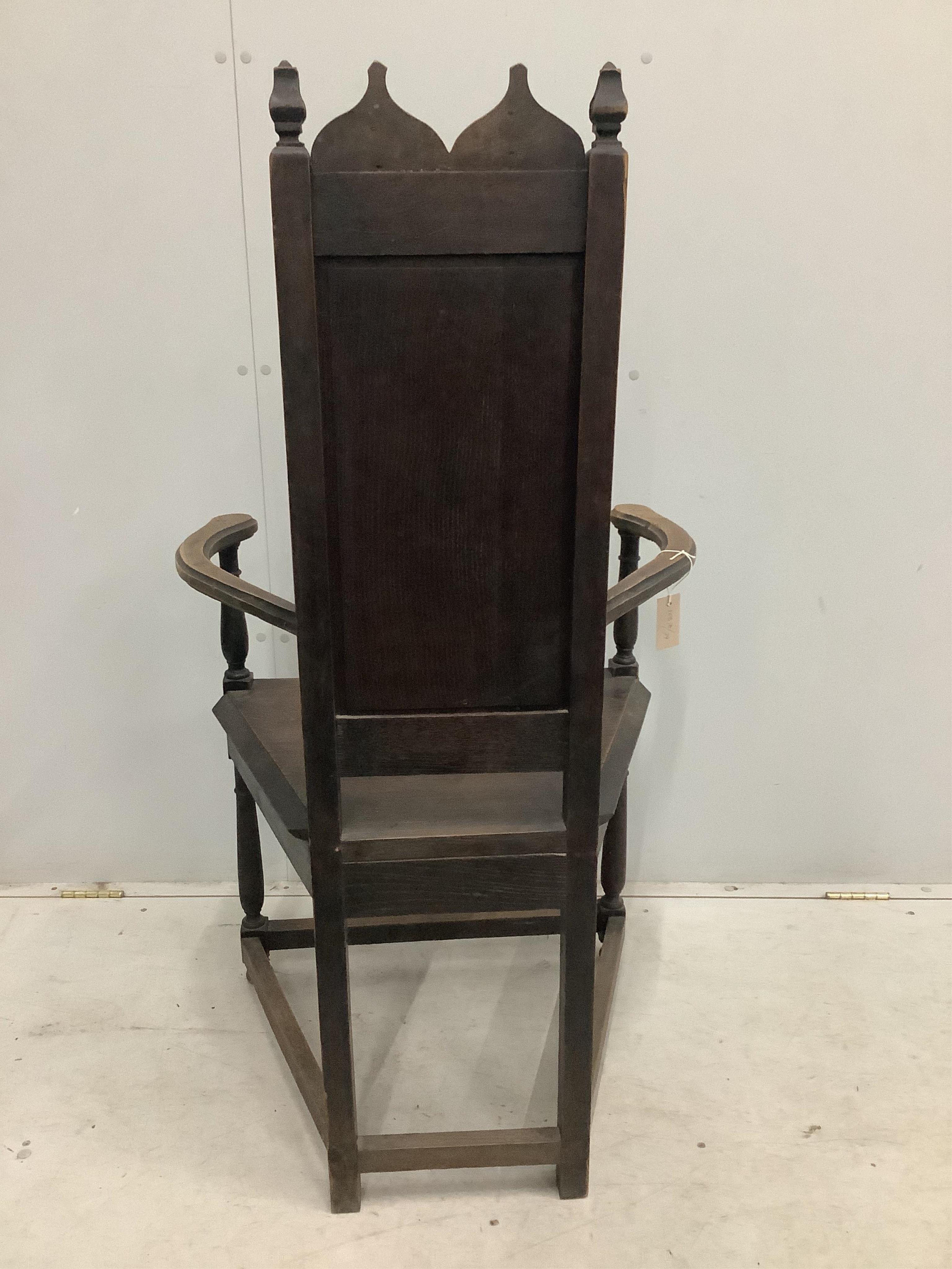 A Continental Gothic Revival oak elbow chair, width 66cm, depth 50cm, height 124cm. Condition - fair